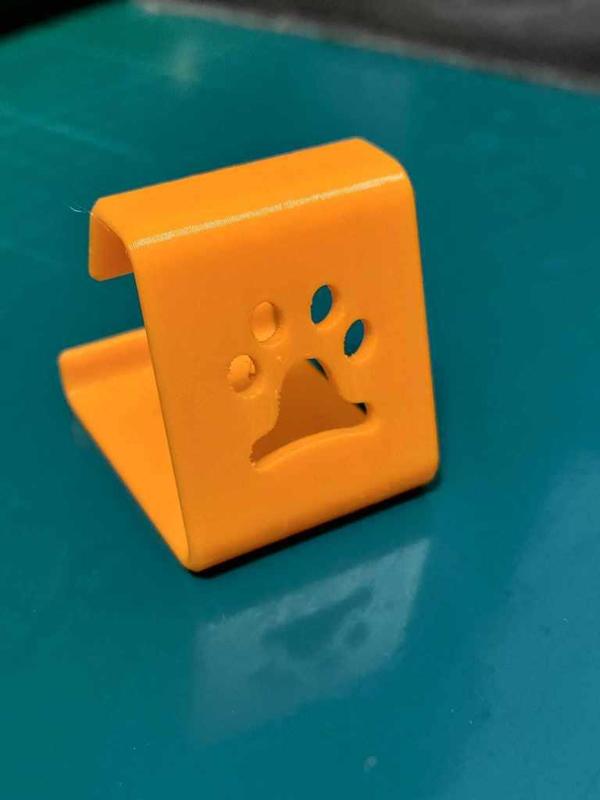 A phonestand with a puppy footprint