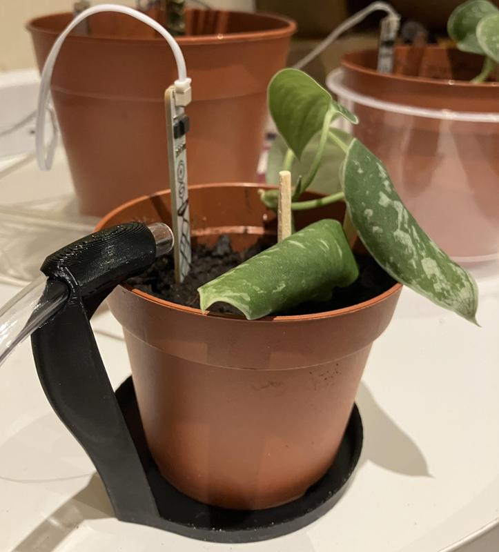 Planter saucer with pipe holder