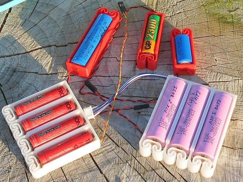 Flexing battery holders with integrated spring