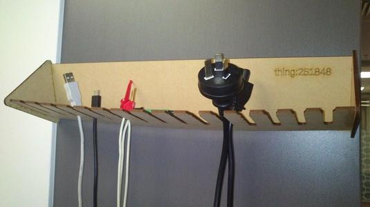 Customizable laser cut cable holder