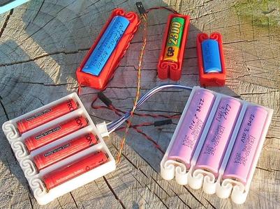 Flexing battery holders with integrated spring