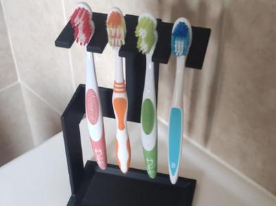 Designer toothbrush holder