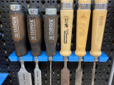 Wood chisel support for peg board