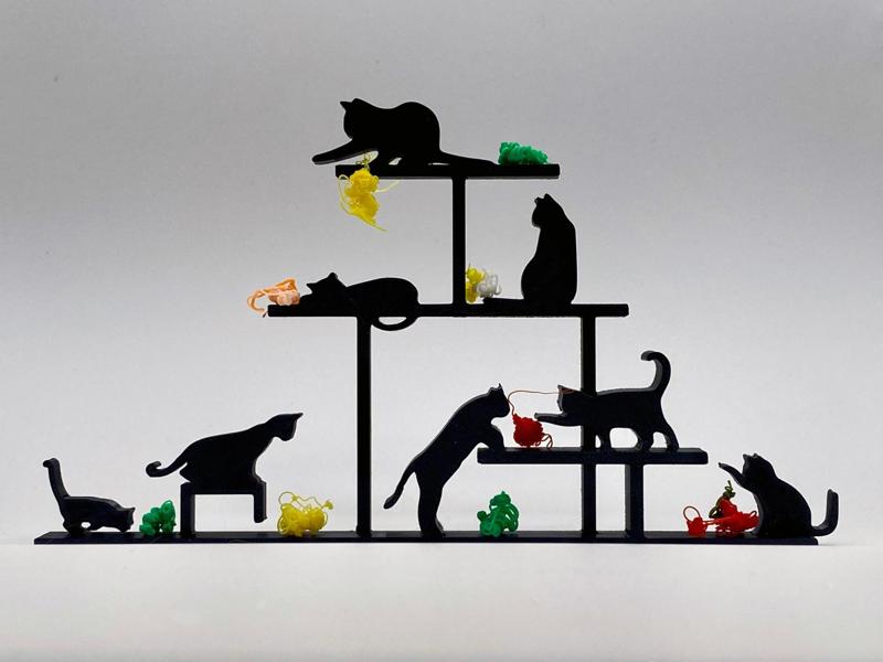Cats play with balls of yarn