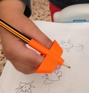 Pen holder, writing aid. Helps hold the pencil.