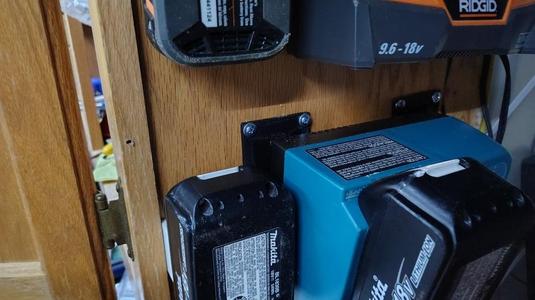 Power tool battery charger hanger