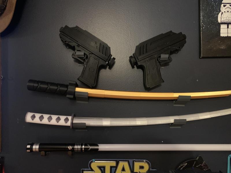 Wall mount hanger for 3-D printed swords w/ built in screw holes
