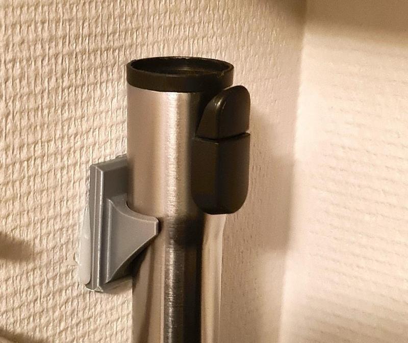 Wall mount for vacuum cleaner tube