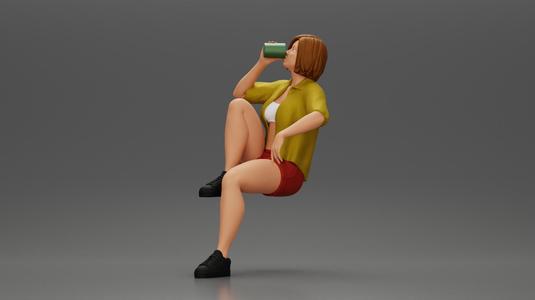 Young woman sitting on a chair hugging her pulled-up leg while drinking