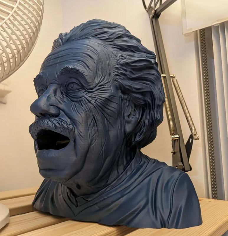 Albert Einstein but his mouth is open so you can put stuff in it   