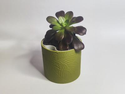 Self watering planter with floral pattern