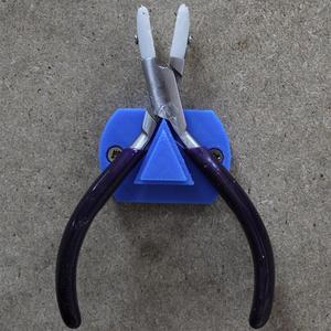 Holder for pliers with screw holes