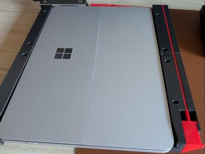 Under-desk docking station for Microsoft Surface laptops