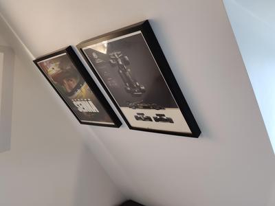 Picture frame hanger for slanted walls