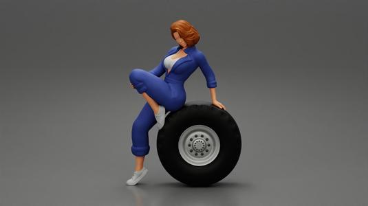2 Models - Sexy girl mechanic in suit sitting on a truck tyre 2