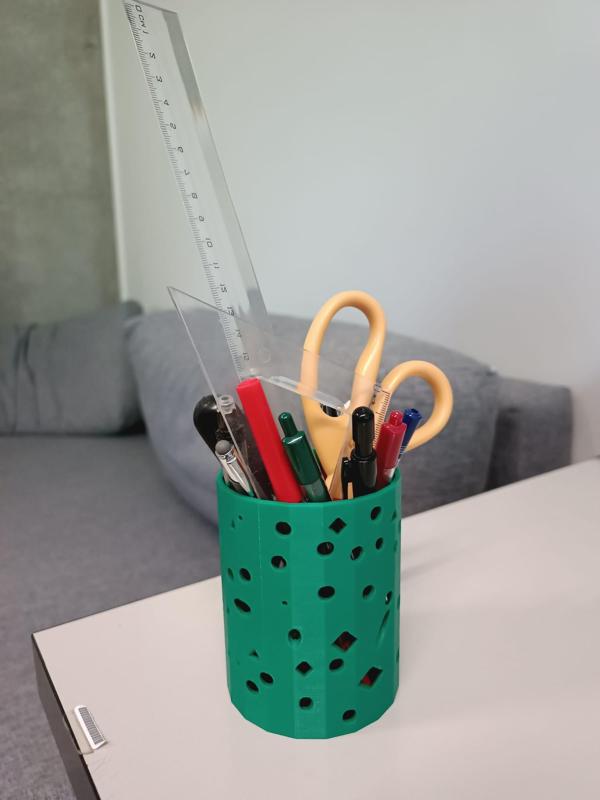 Pencil holder with holes of geometric shapes