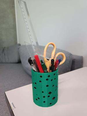 Pencil holder with holes of geometric shapes
