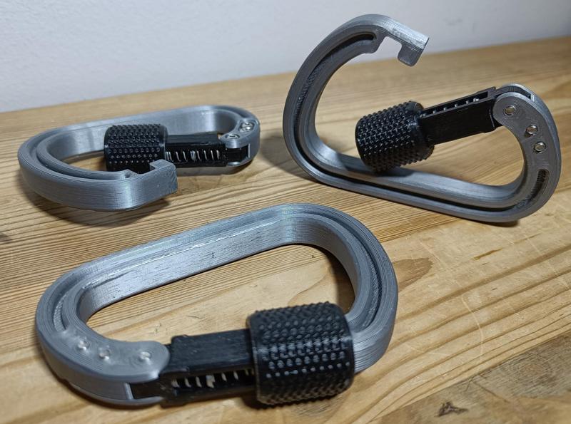 Carabiner with spring loaded secured lock
