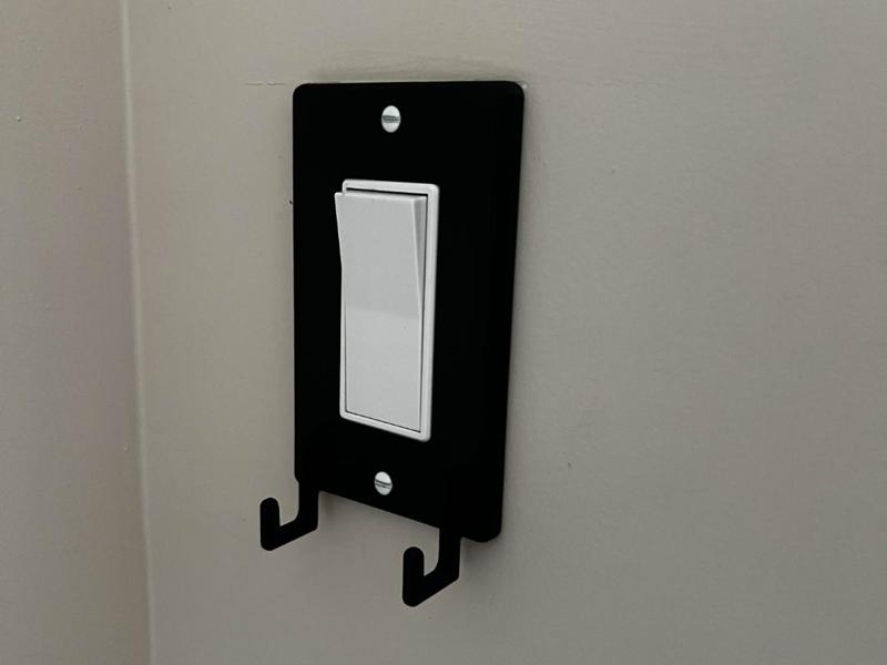 Light switch cover with hooks