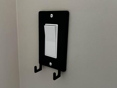 Light switch cover with hooks