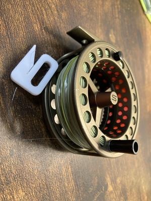Fishing line stopper for fly reel