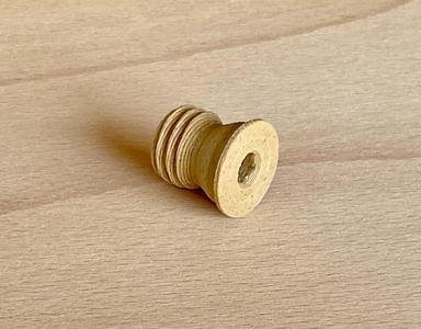 Plug printed with wood filament to close bore in a wooden frame of a window