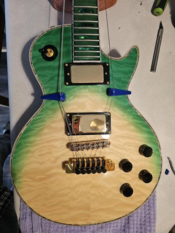 Les Paul fretwork string retractor