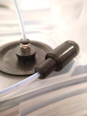 Filament feed tube end cap