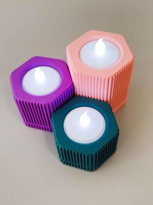 Hexagon candle holder with grooved texture.