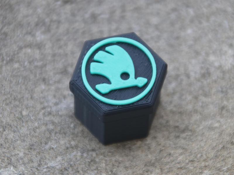Rim bolt caps with Škoda logo.