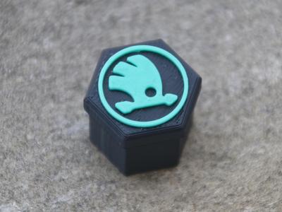 Rim bolt caps with Škoda logo.