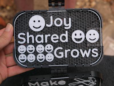 "Joy Shared Grows" sign