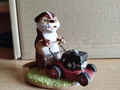Cute otter with a mower