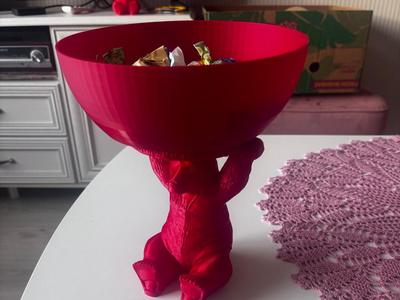 Bear holding a snack bowl