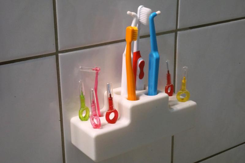 Tooth brush holder with holes for interdental brush