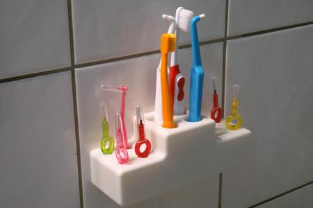 Tooth brush holder with holes for interdental brush