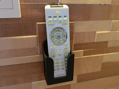 Universal wall-mounted holder for remote