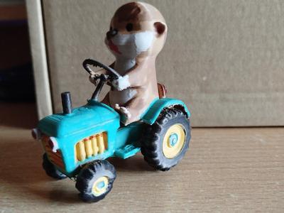 Cute otter with garden tractor