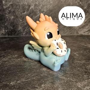 Baby dragon eating a donut