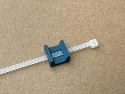 Wall holder for cable fixing with tie wrap hole