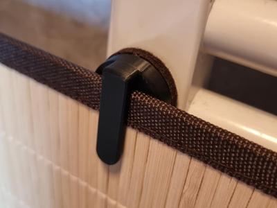 Magnetic laundry basket lid holder