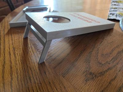 Table top cornhole with desiccant pouches