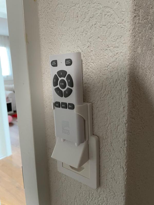Light switch cover with remote control holder