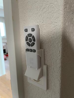 Light switch cover with remote control holder