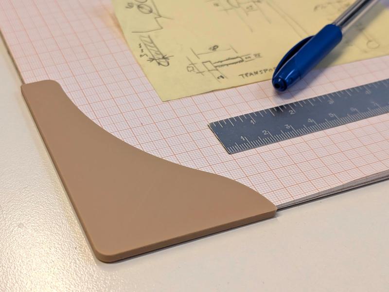 Anti curling corner shields for notepad paper