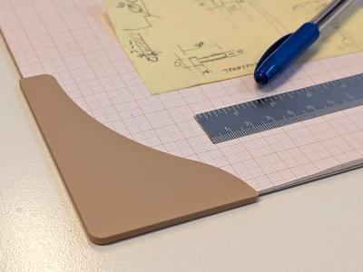 Anti curling corner shields for notepad paper
