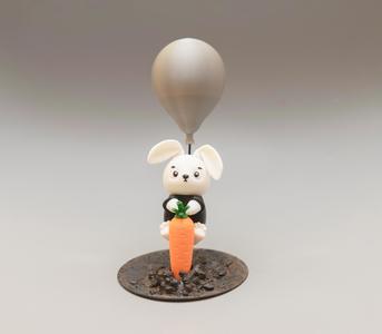 Cute figure of bunny infiltrator flying on balloon