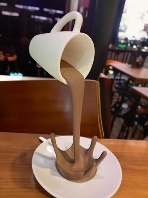 Floating coffee cup sculpture 