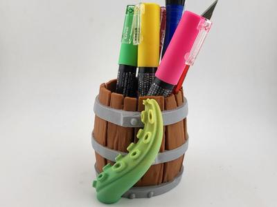 Pen holder in the shape of a barrel with kraken