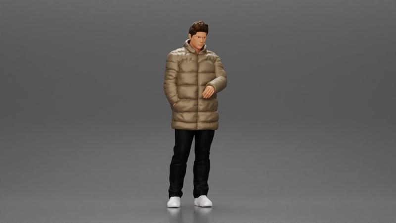 Man in long puffer jacket standing with his hand in his pocket lost in thought